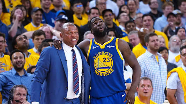 Golden State Warriors forward Draymond Green (23) talks to LA Clippers head coach Doc Rivers (left) 